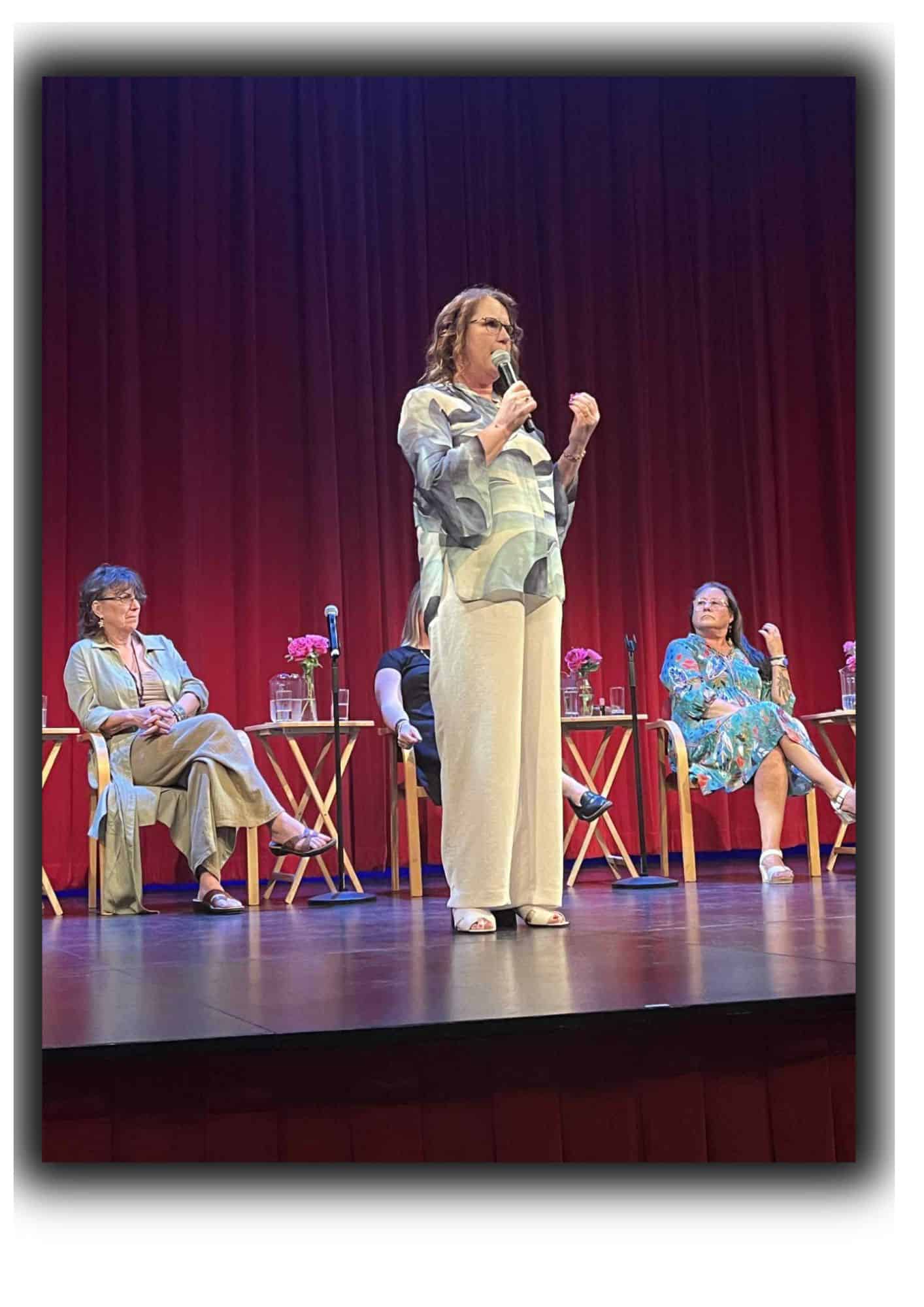 Arlene Mills on stage with microphone at Mary Winspear Centre in Victoria